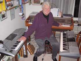 Herman surrounded by his three keyboards